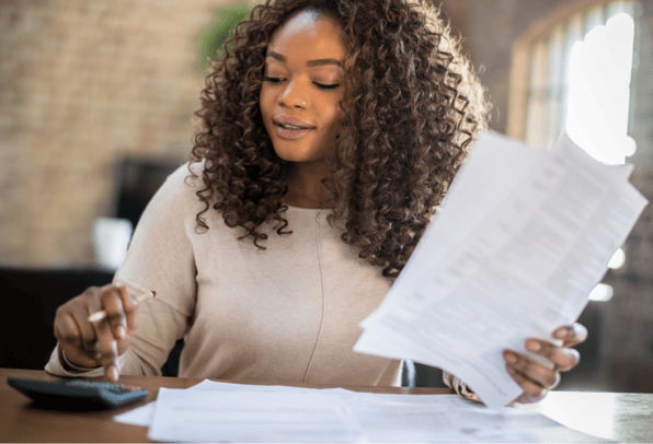 A woman looking at her financial tasks she will do at the start of summer.