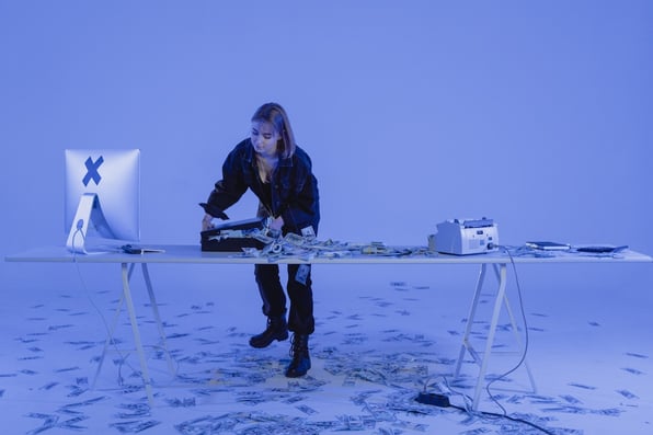 A woman counting her earnings from committing investment scams 