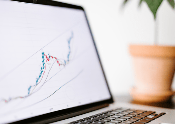 A close up graph of stock prices showing the benefits of stocks and shares.
