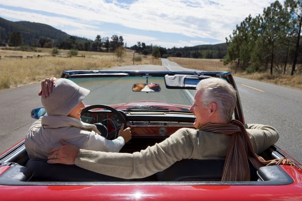 Smiling couple in a car on the open road