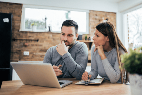 Young couple assessing their current financial situation at the start of the year due to the rising cost of living.
