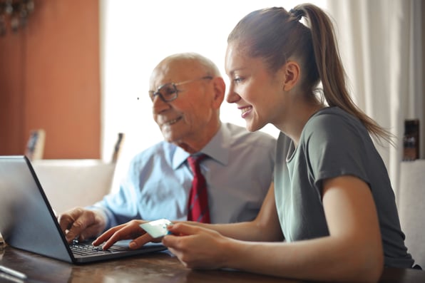 An adviser consulting an elderly man on how much extra he can pay into his pension. 