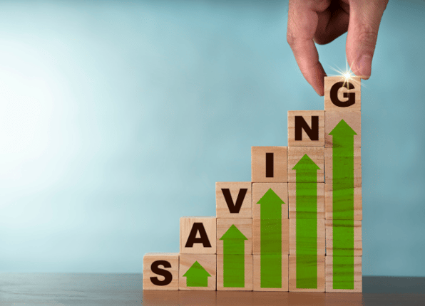 Rising wooden blocks spelling out ‘saving’, showing you should save money this year.
