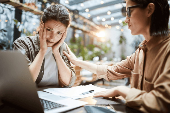 A woman consoling her friend who has just rushed into a new investment without considering the dangers
