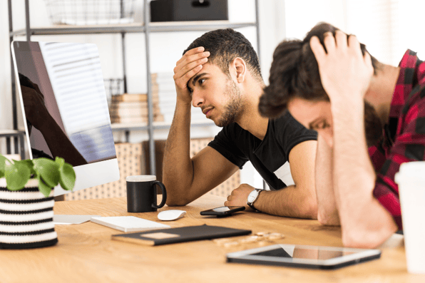 Two men sad after losing their investments because of rushing into current trends